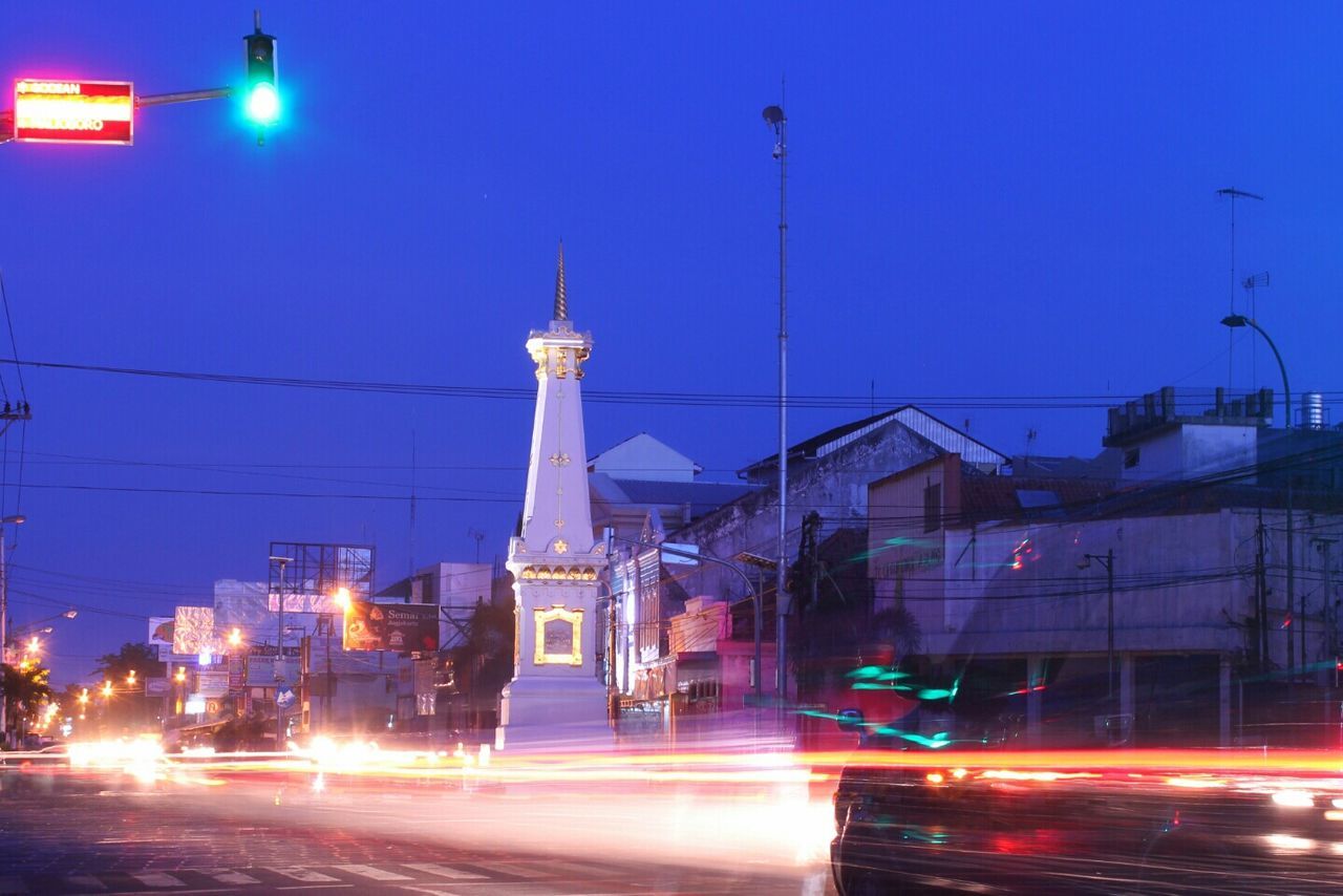 Light trails on city street at dawn