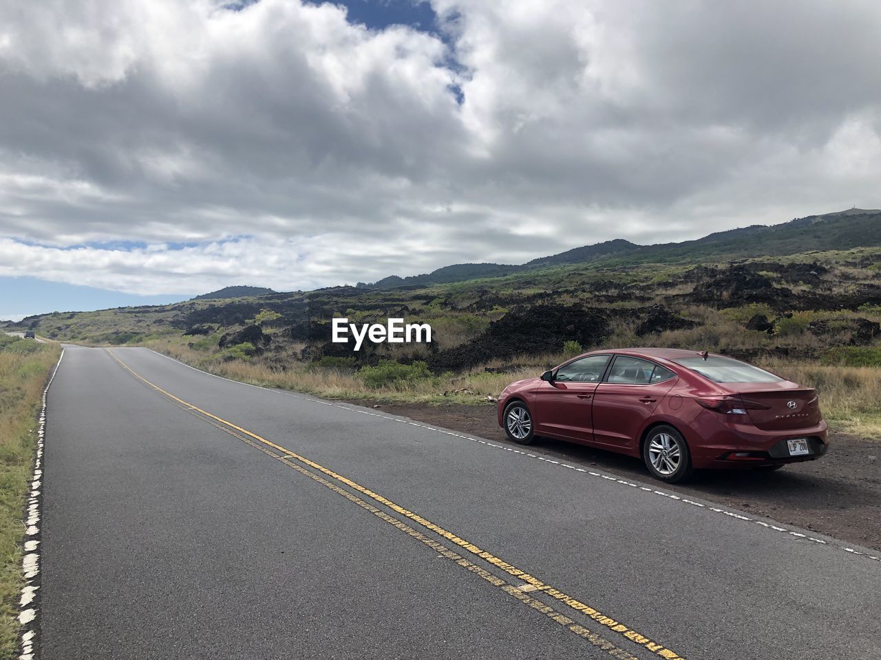 CARS ON ROAD AGAINST SKY