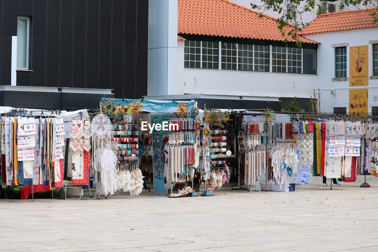 Market  on street amidst buildings in city