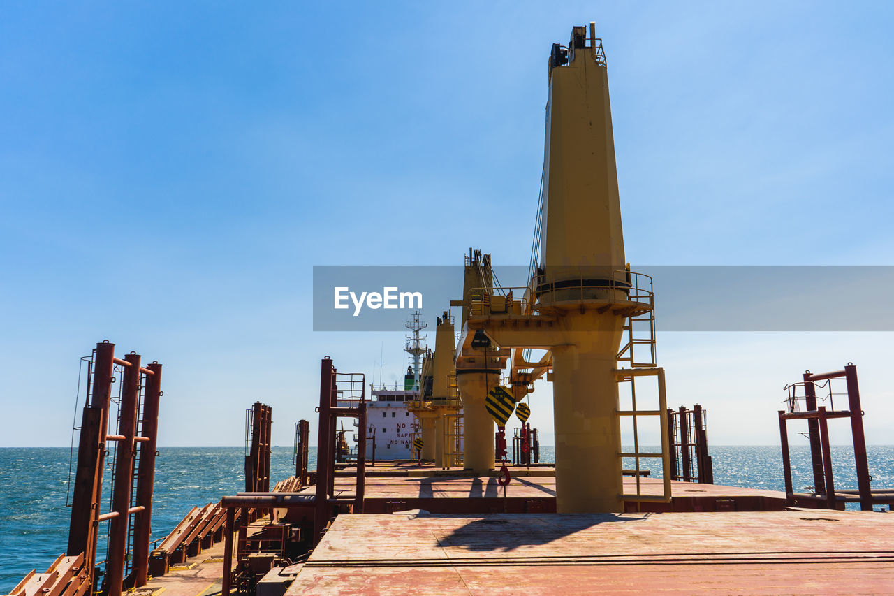 Offshore platform in sea against sky