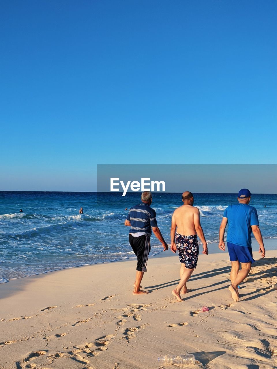 Old people friends forever walking on beach 