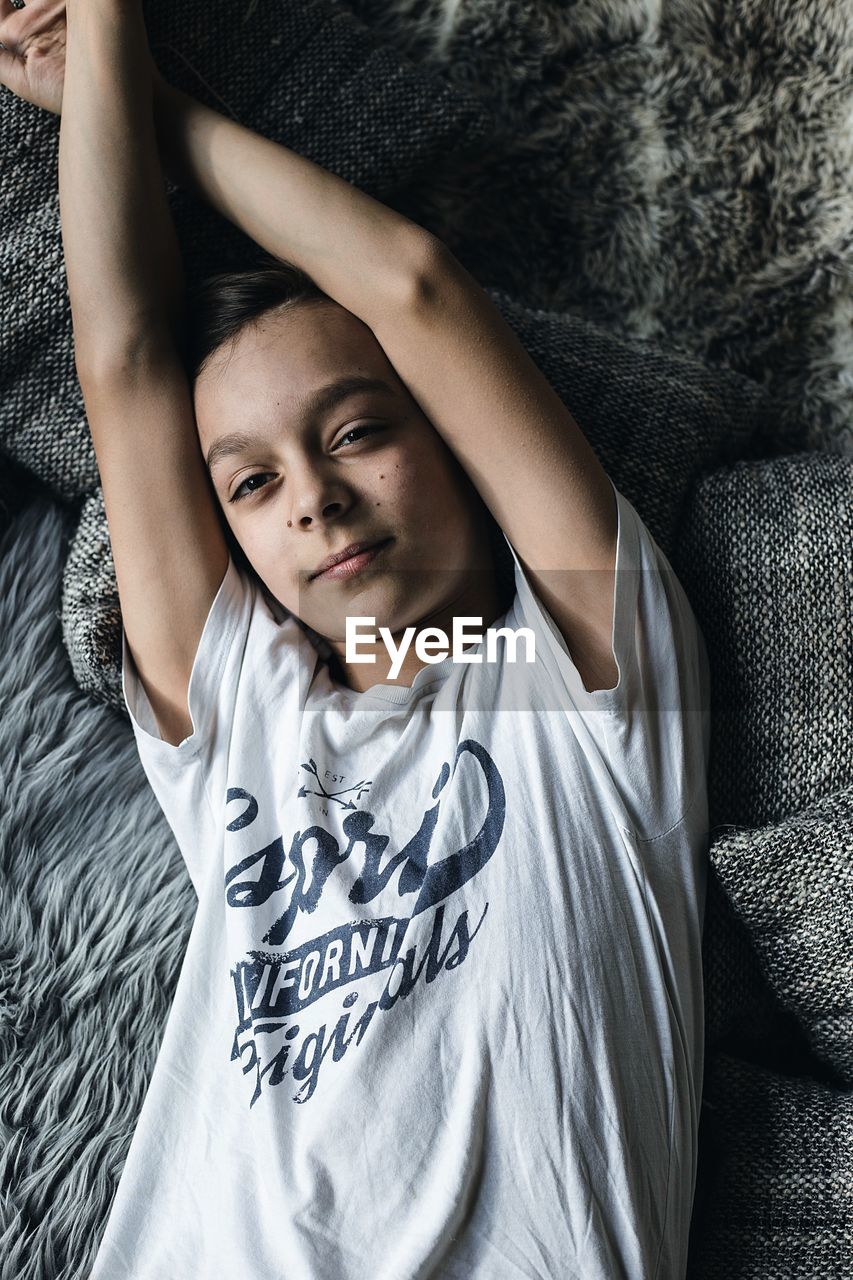 Directly above shot of girl lying on bed at home