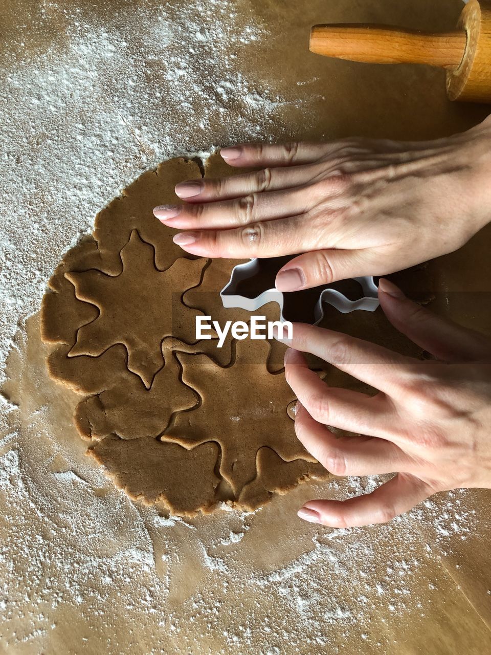 Cropped image of hands making cookies during christmas