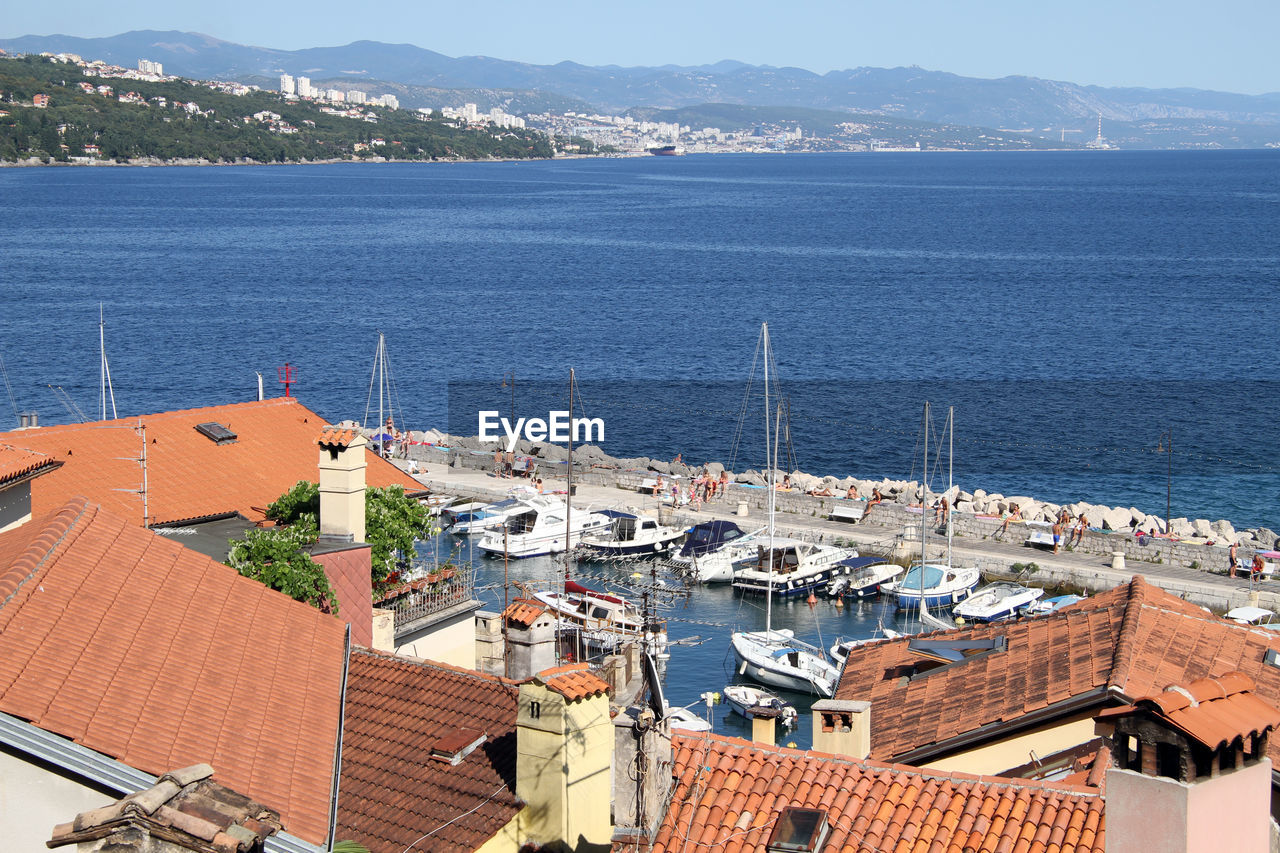 High angle view of buildings by sea