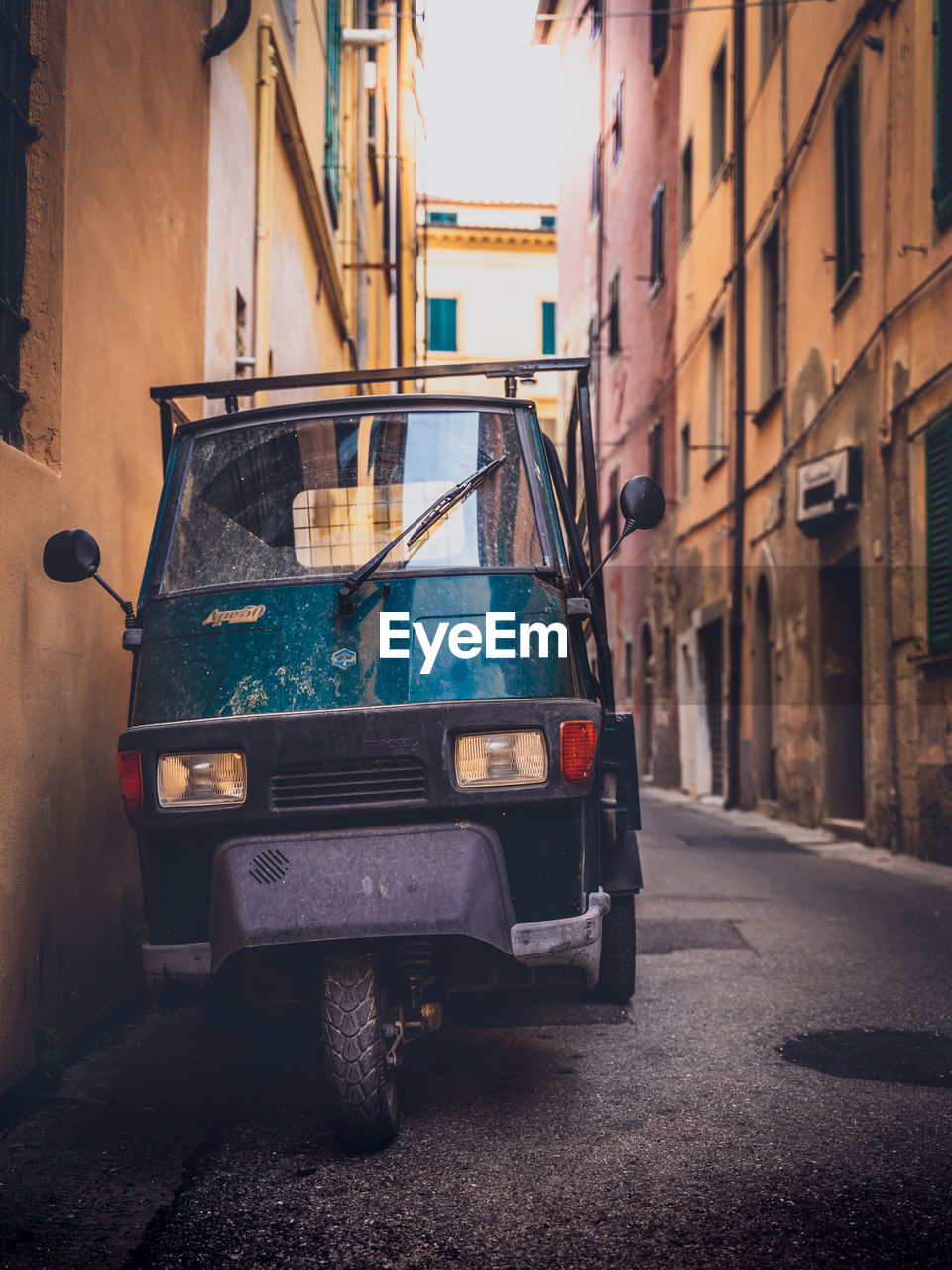 CAR ON STREET AMIDST BUILDINGS