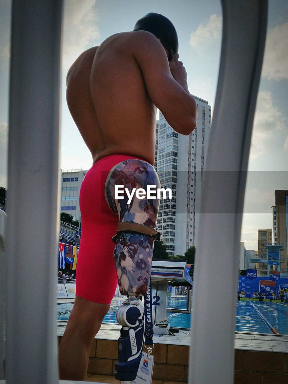 FULL LENGTH OF SHIRTLESS BOY IN SWIMMING POOL