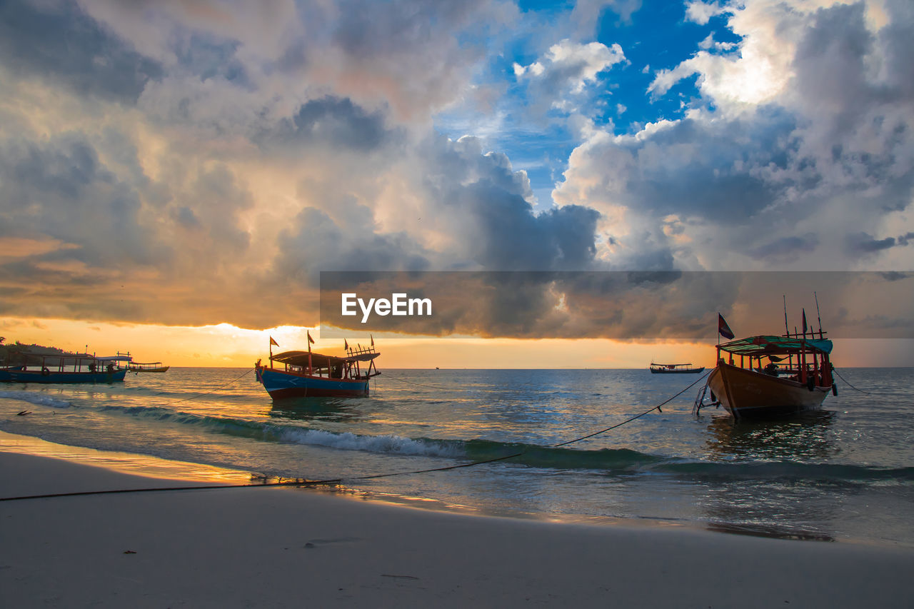 Koh rong island, cambodia at sunrise. strong vibrant colors, boats and ocean