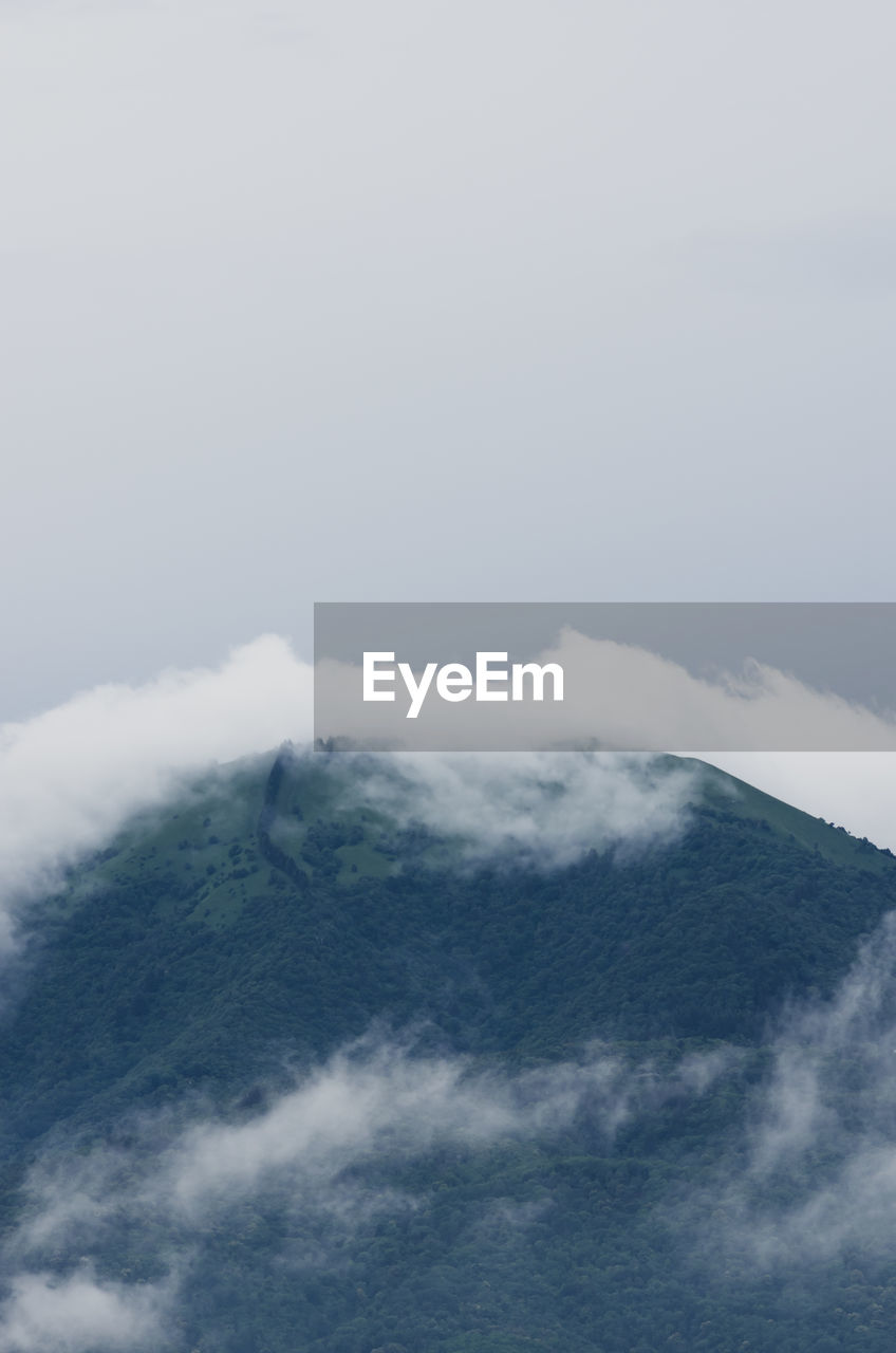 AERIAL VIEW OF CLOUDS OVER MOUNTAINS