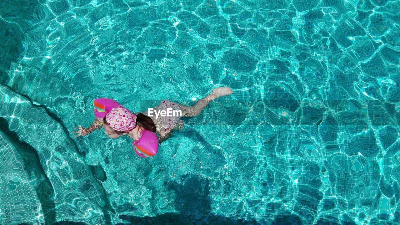 High angle view of girl swimming in pool