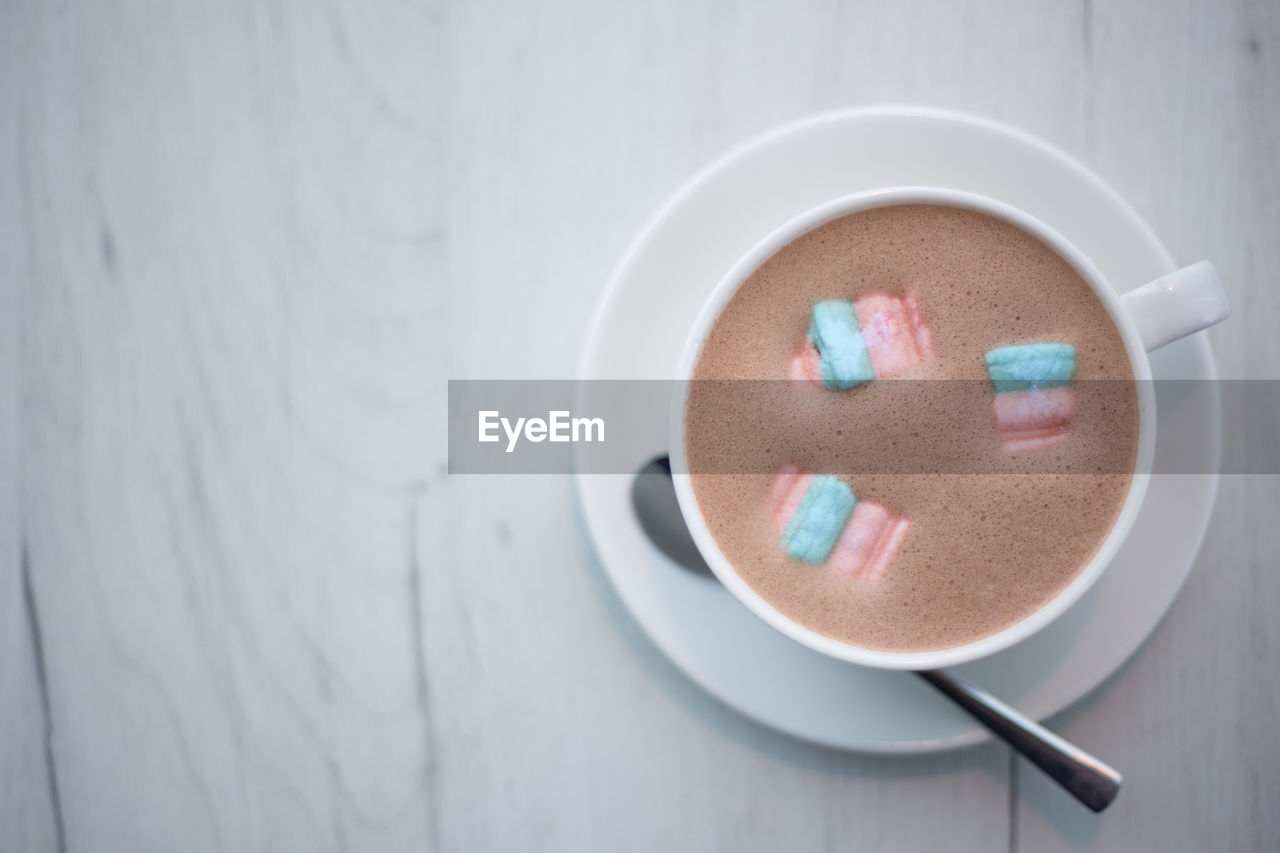 A cup of cocoa with marshmallows in a cafe on a wooden table