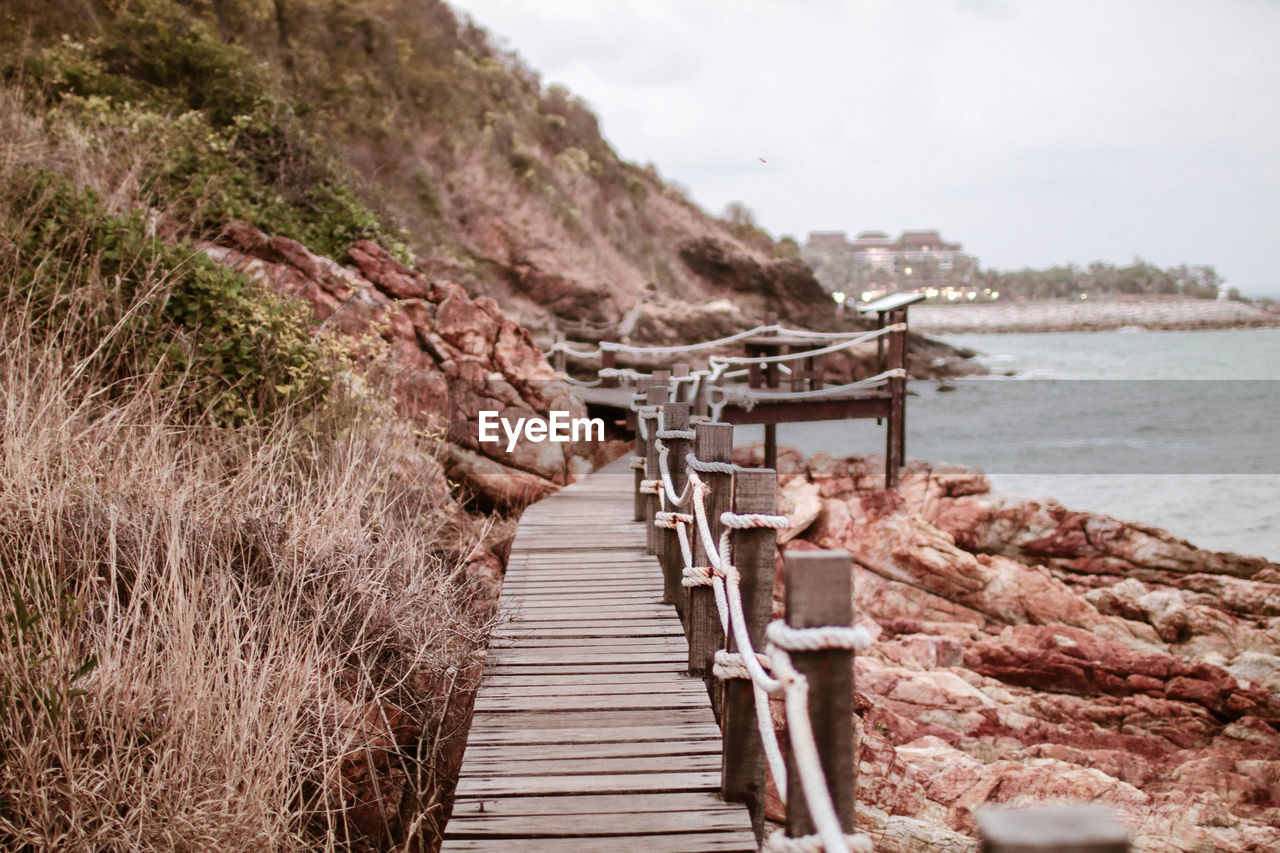 Empty boardwalk by sea