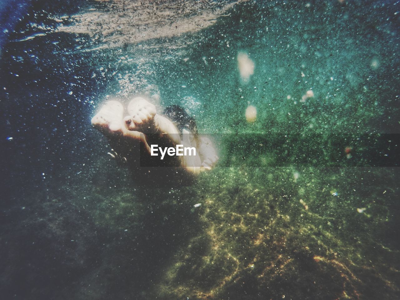 CLOSE-UP OF WOMAN SWIMMING IN WATER