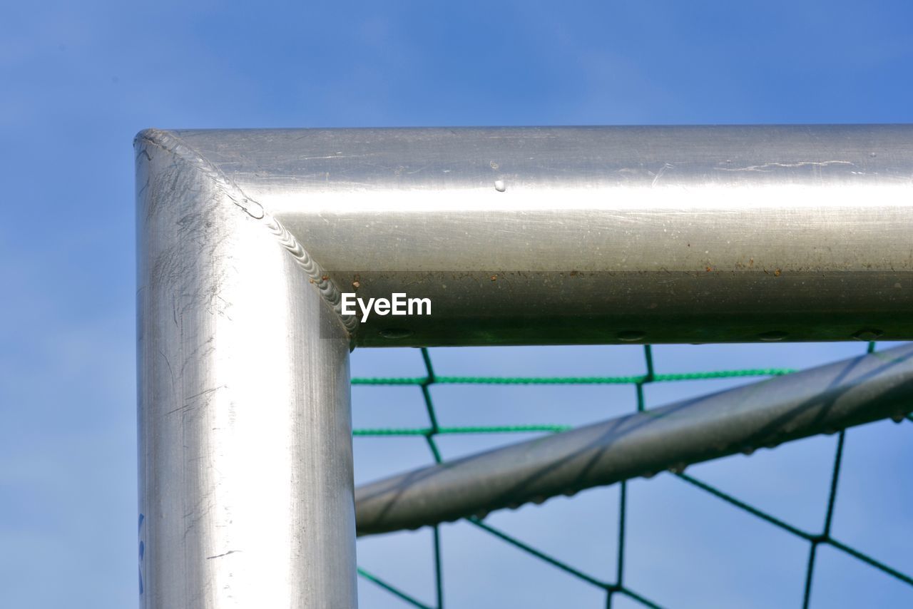 LOW ANGLE VIEW OF METAL PIPE AGAINST SKY
