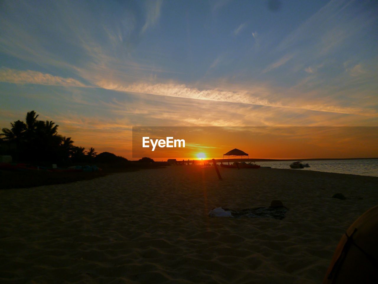 SCENIC VIEW OF BEACH DURING SUNSET