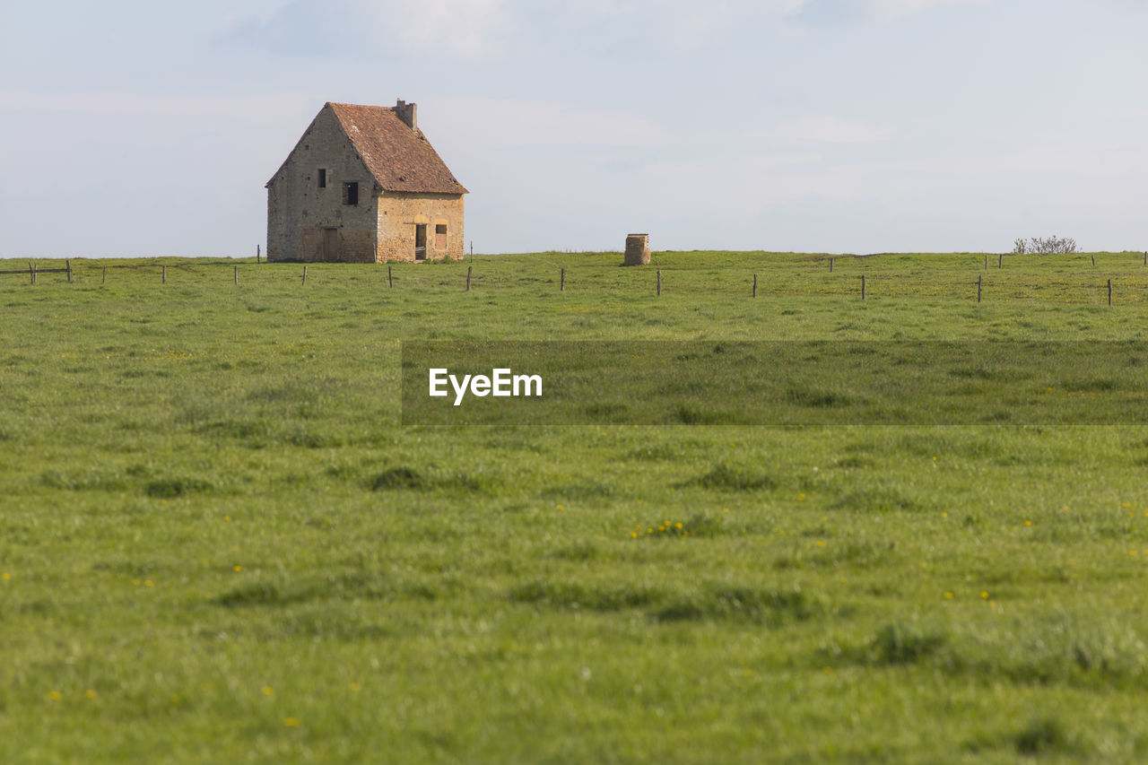 prairie, pasture, plain, grass, grassland, architecture, built structure, building exterior, landscape, field, land, plant, natural environment, sky, steppe, building, nature, environment, meadow, rural scene, rural area, hill, house, green, abandoned, cloud, scenics - nature, no people, horizon, day, residential district, non-urban scene, outdoors, history, remote, agriculture, farm, agricultural building, beauty in nature, tranquility, the past, loneliness, horizon over land, copy space, farmhouse, tranquil scene, hut, plateau