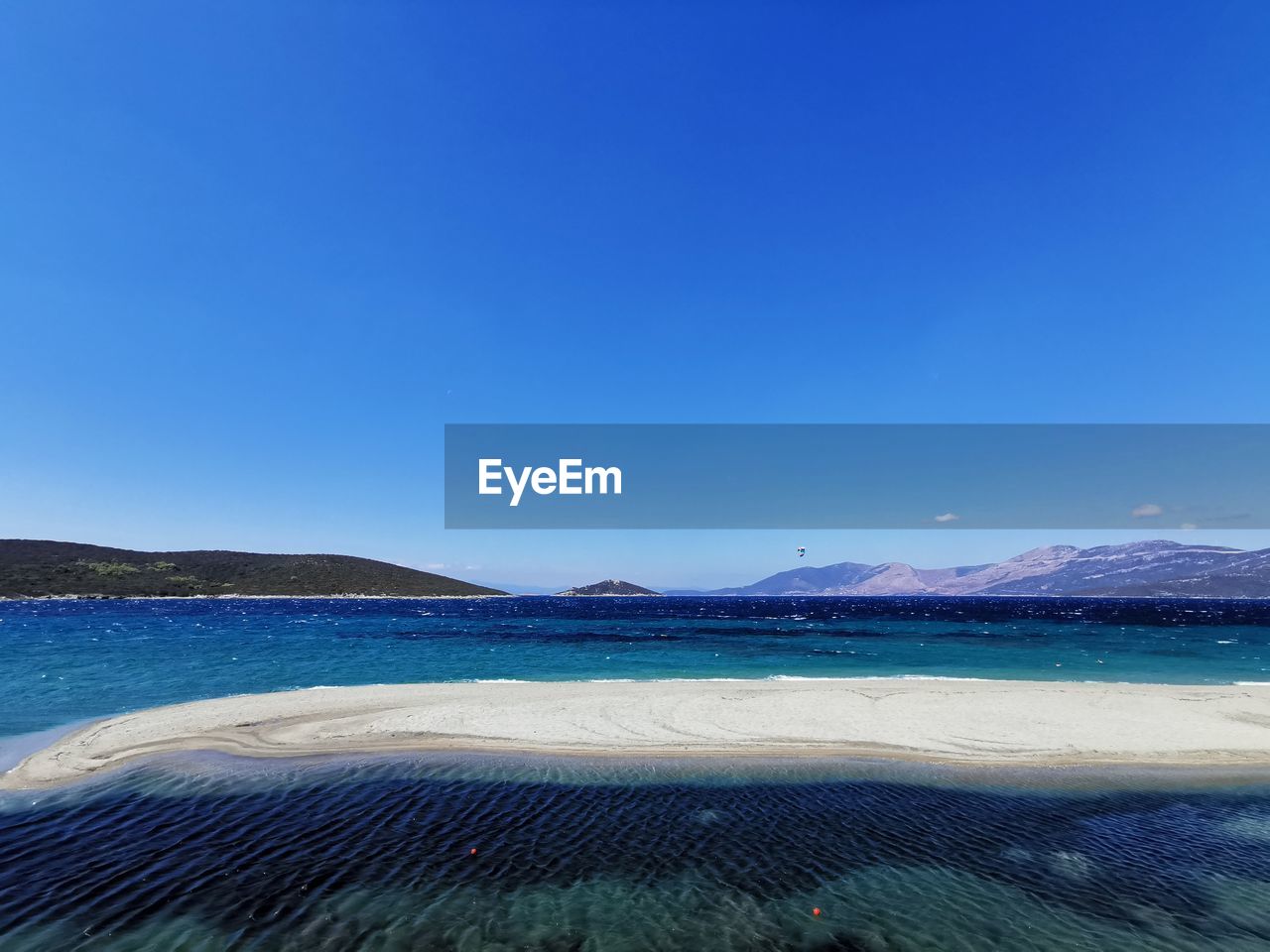 PANORAMIC VIEW OF LAKE AGAINST CLEAR BLUE SKY