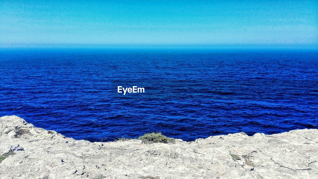 Scenic view of sea against blue sky