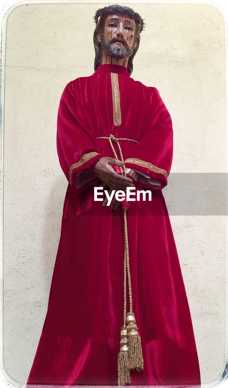 Statue of jesus christ dressed in crimson robe