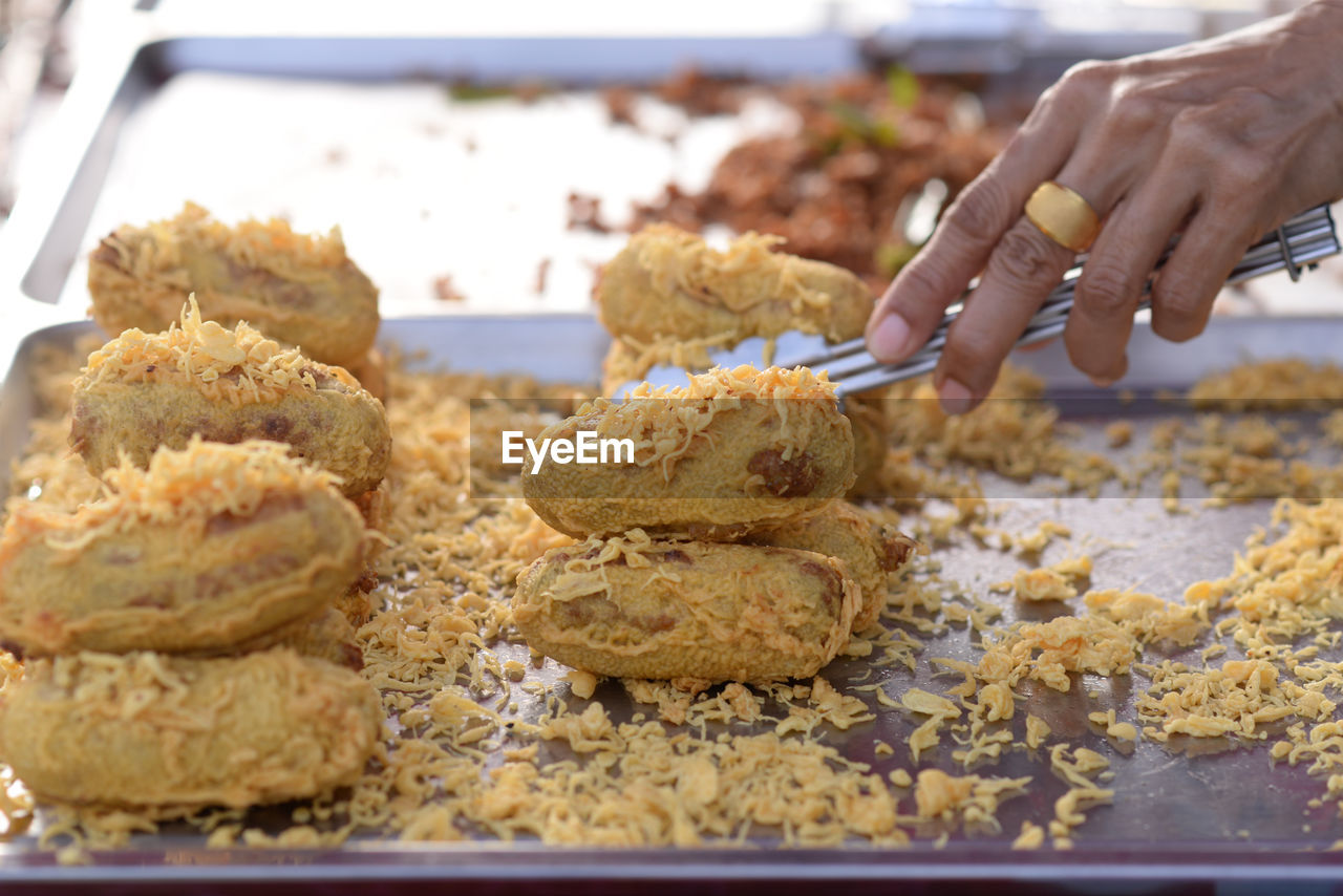 Battered and deep-fried unripe rice and grated coconut banana rollsy, thai dessert.