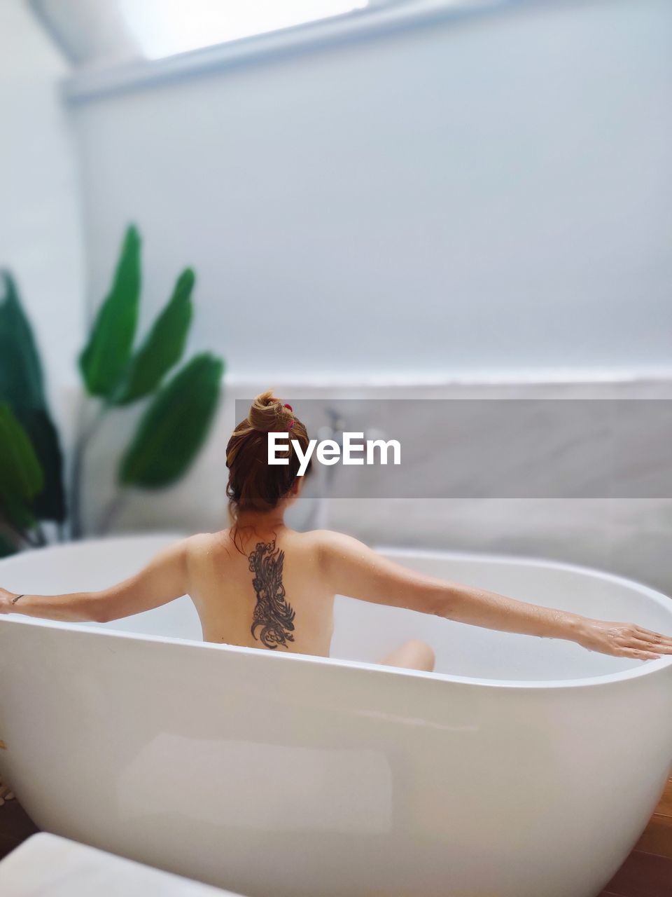 Cropped image of woman in bathtub
