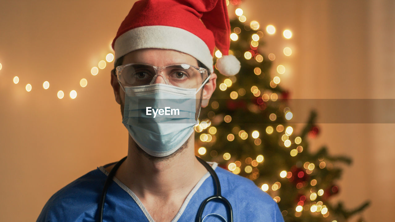 Doctor with mask on christmas background