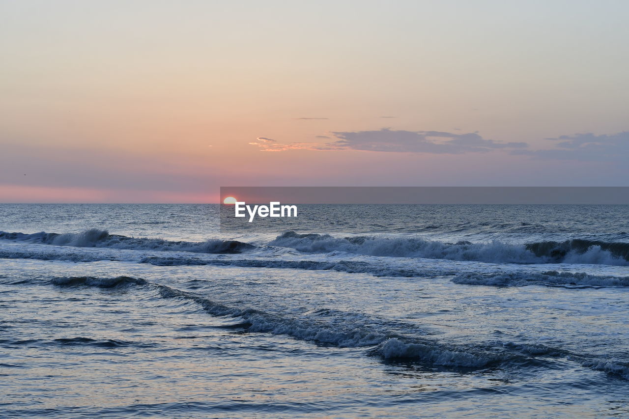 Scenic view of sea against sky during sunrise