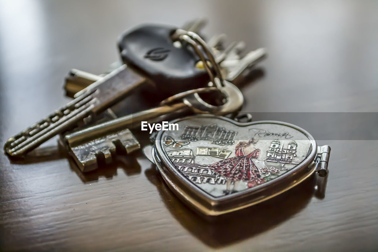 Close-up of heart shaped key ring on table