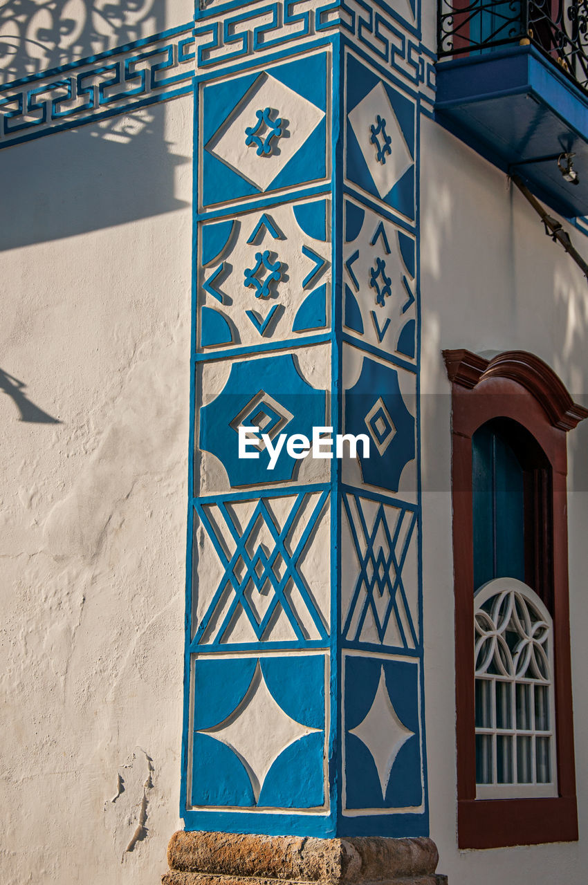 Close-up of the colorful wall decoration of old house at the sunset in paraty, brazil