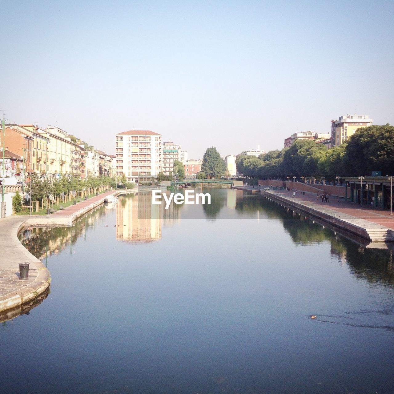 VIEW OF RIVER IN TOWN AGAINST CLEAR SKY