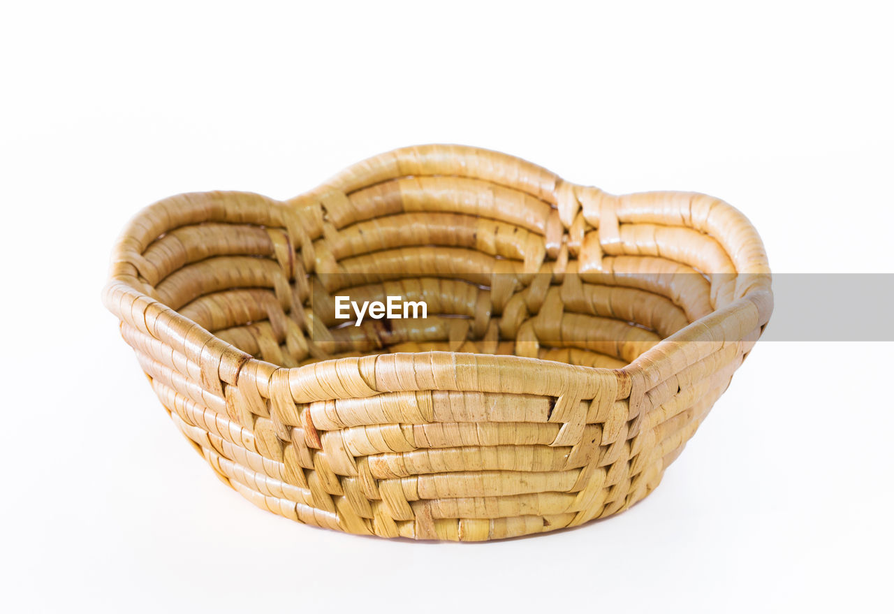HIGH ANGLE VIEW OF WICKER BASKET AGAINST WHITE BACKGROUND