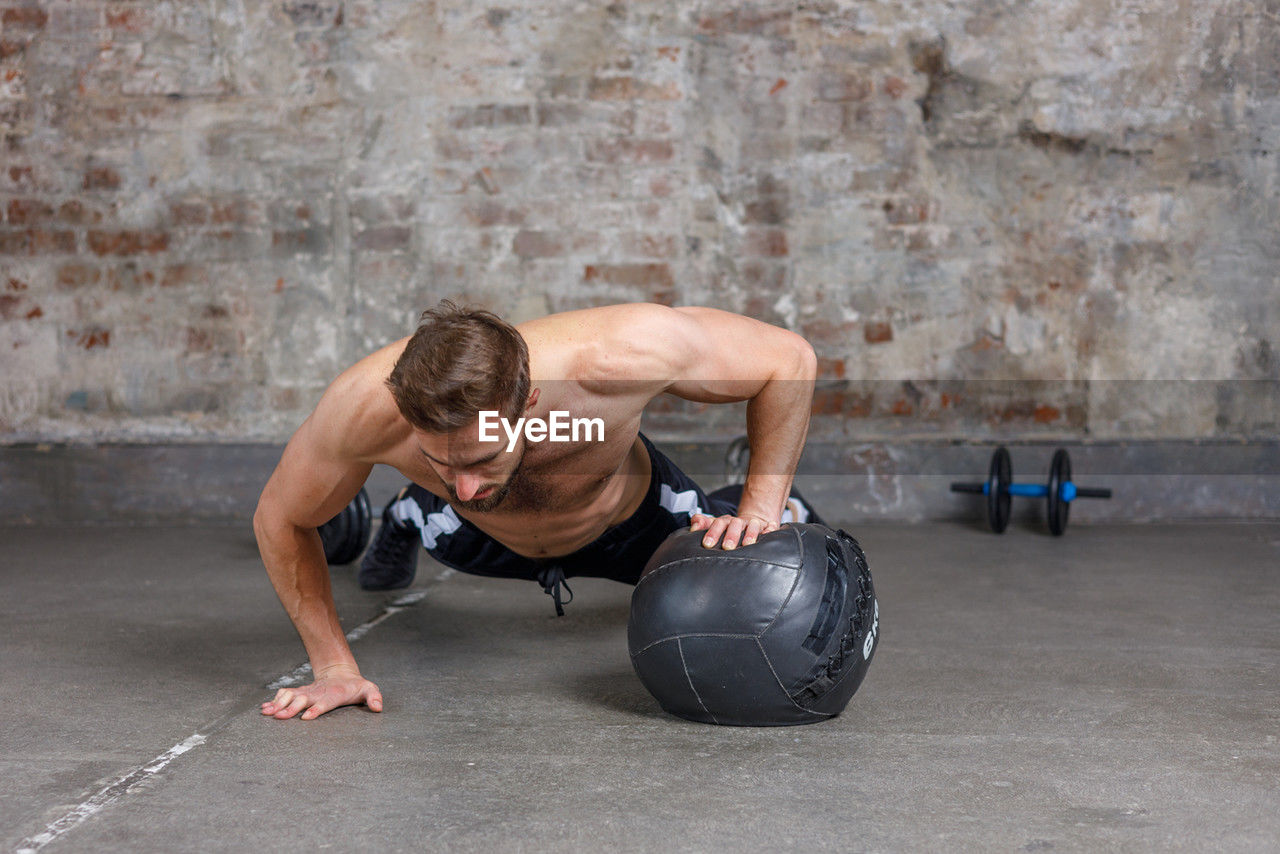 side view of man exercising in gym