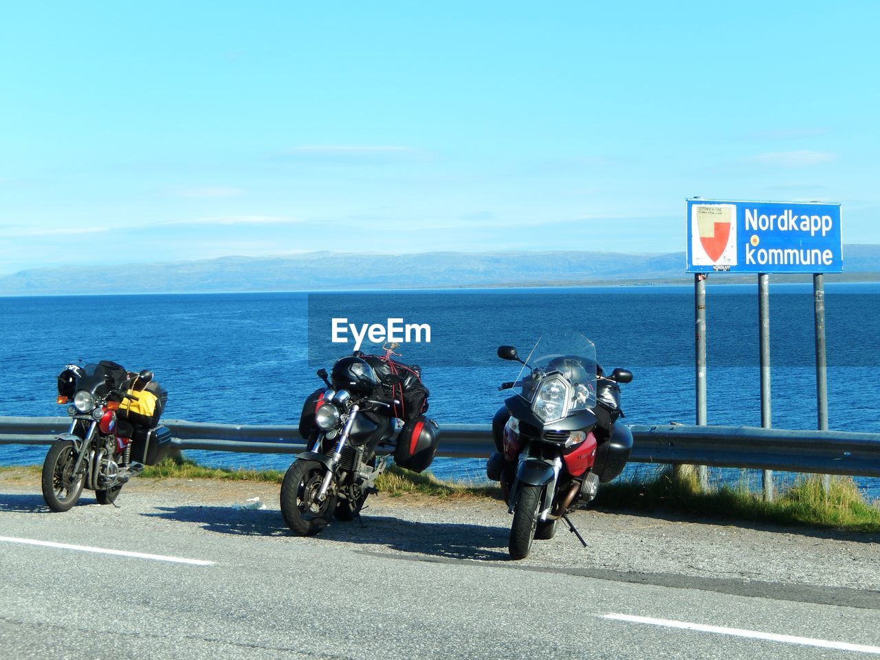 PEOPLE RIDING MOTORCYCLE ON ROAD