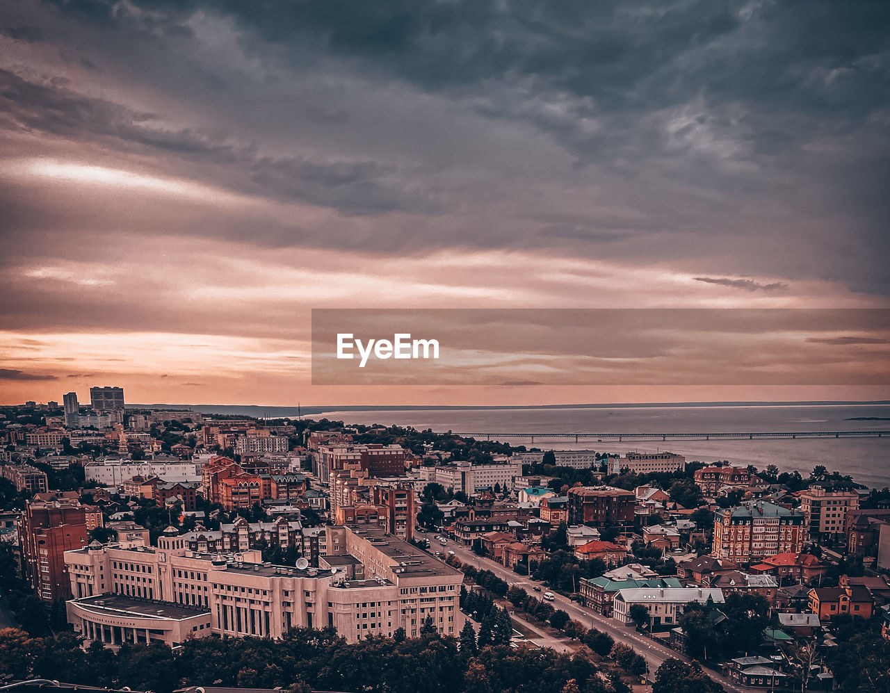 HIGH ANGLE VIEW OF TOWNSCAPE AGAINST SKY DURING SUNSET