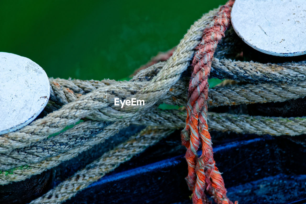 Close-up of rope tied on bollard