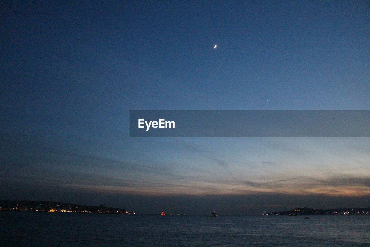 SEA AGAINST SKY AT NIGHT