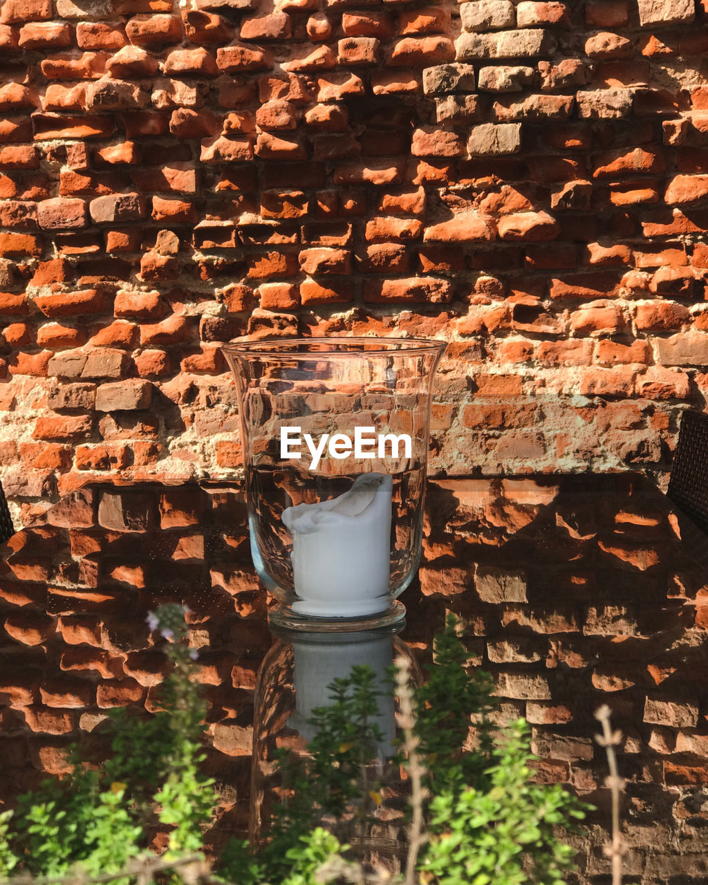 HIGH ANGLE VIEW OF BRICK WALL WITH PLANTS