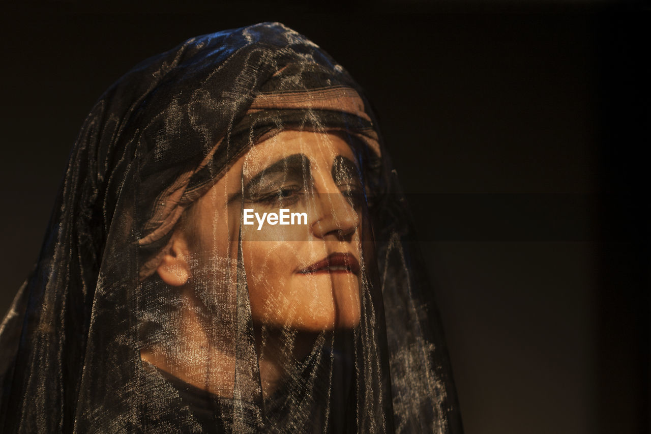 Close-up of performer wearing veil in theater