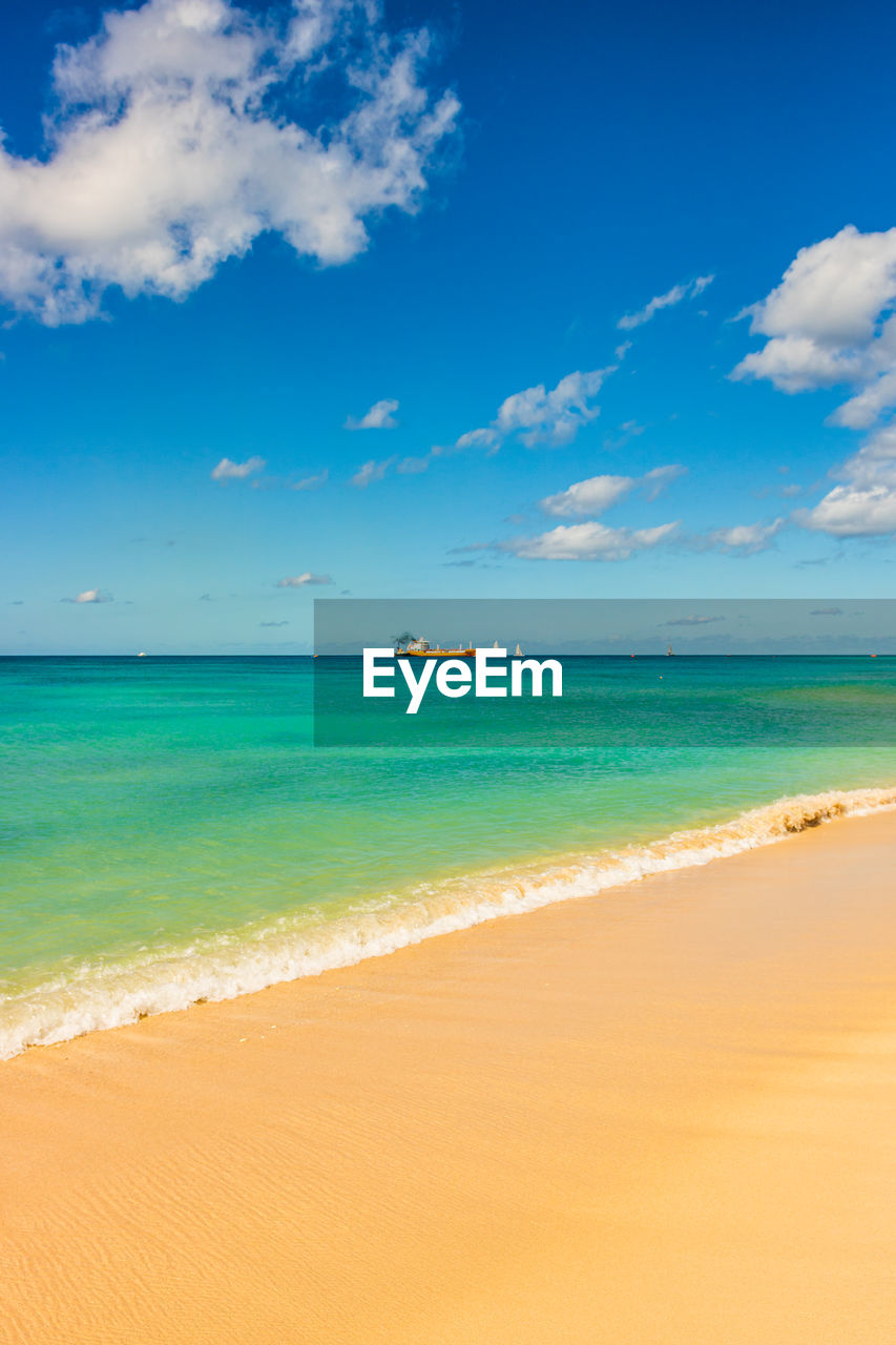 SCENIC VIEW OF BEACH AGAINST BLUE SKY