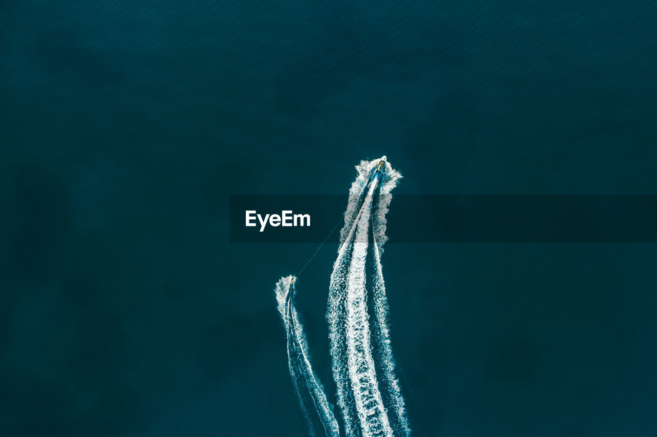 Aerial view of people jet boating in sea