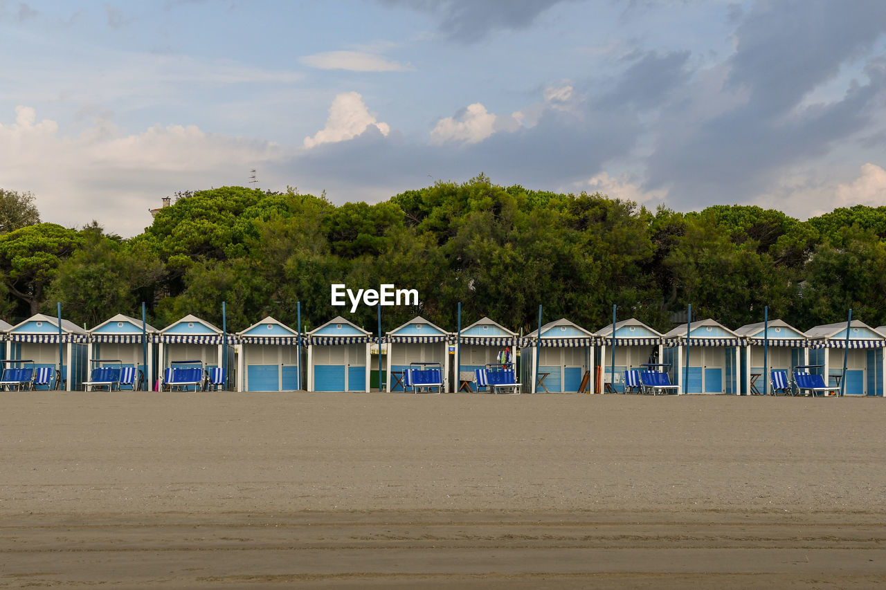 Row of huts on the empty beach of venice lido at dawn, venice, italy
