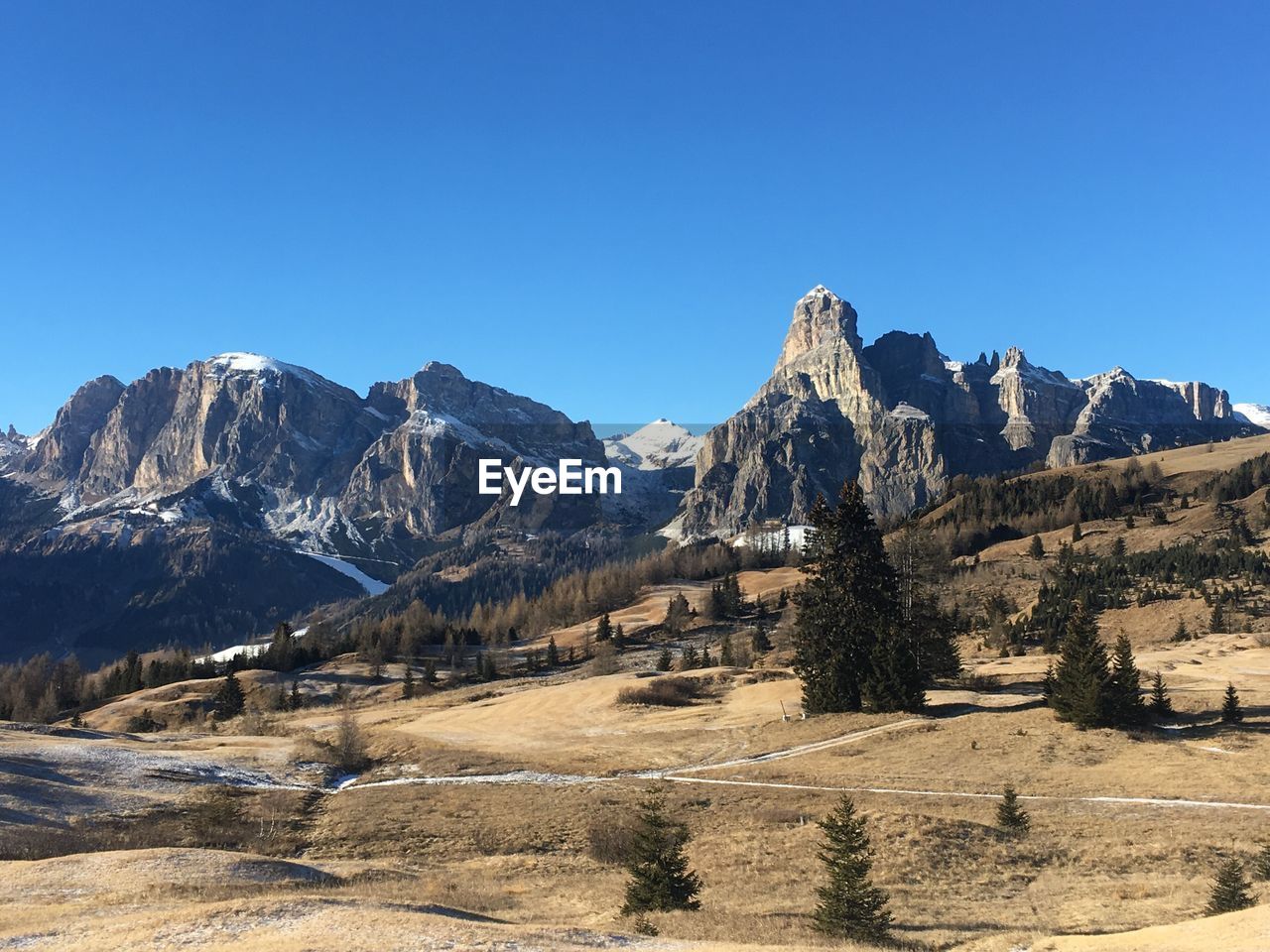 Scenic view of mountains against clear blue sky