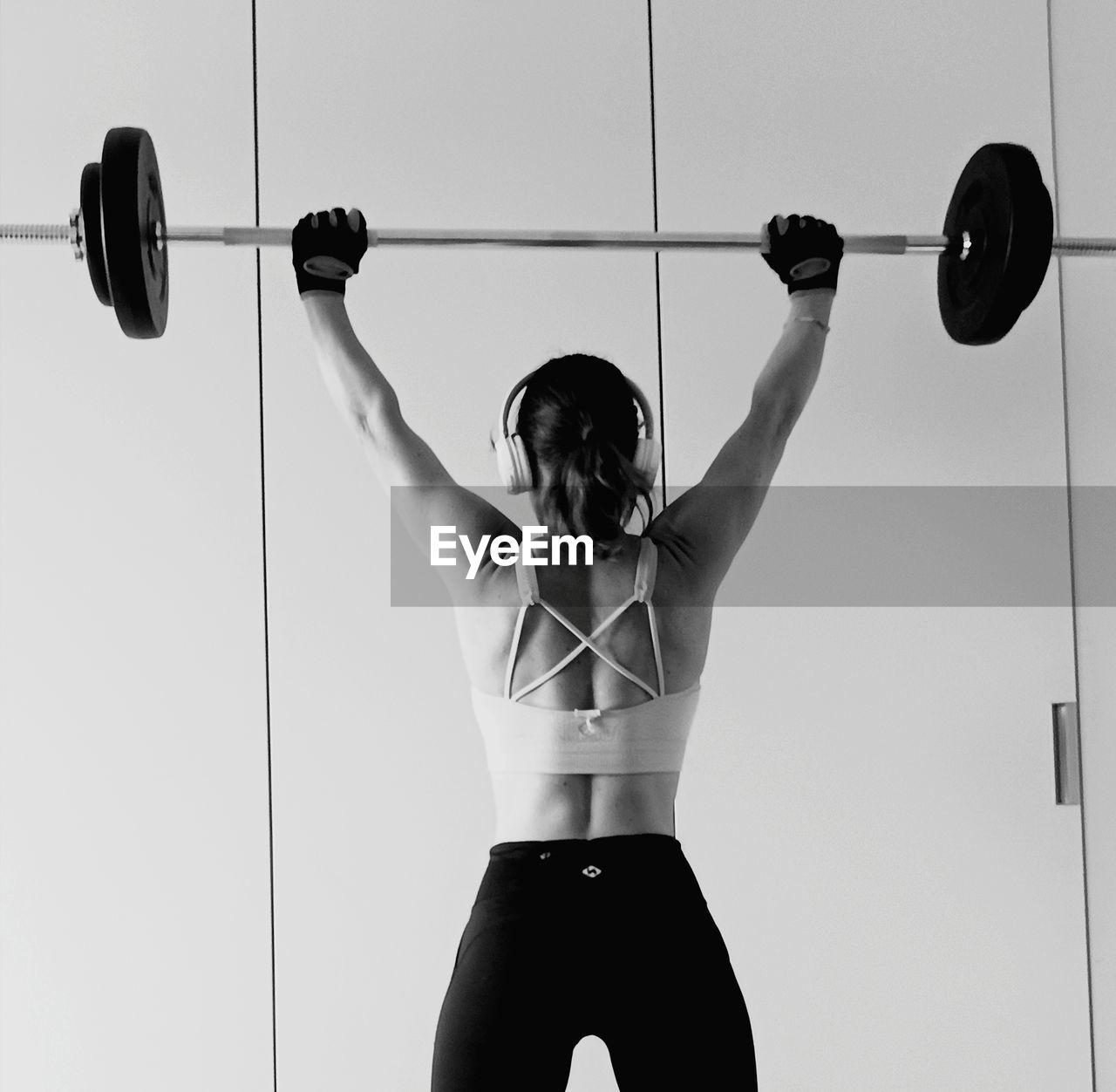 Back woman weight lifting
