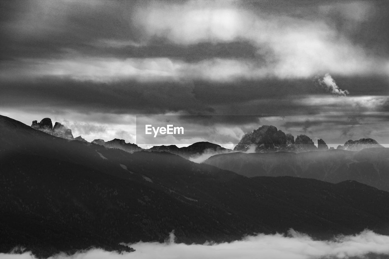 SCENIC VIEW OF STORM CLOUDS OVER MOUNTAINS