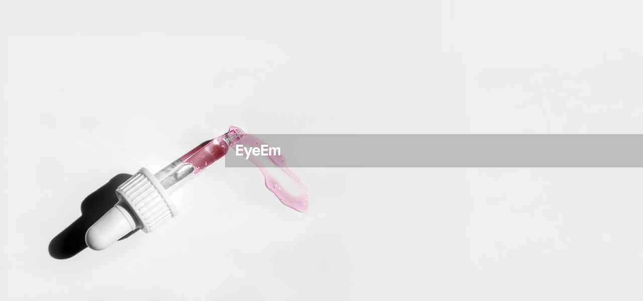 Pipette with peeling on white background. cosmetics and healthcare concept. dose of serum, retinol