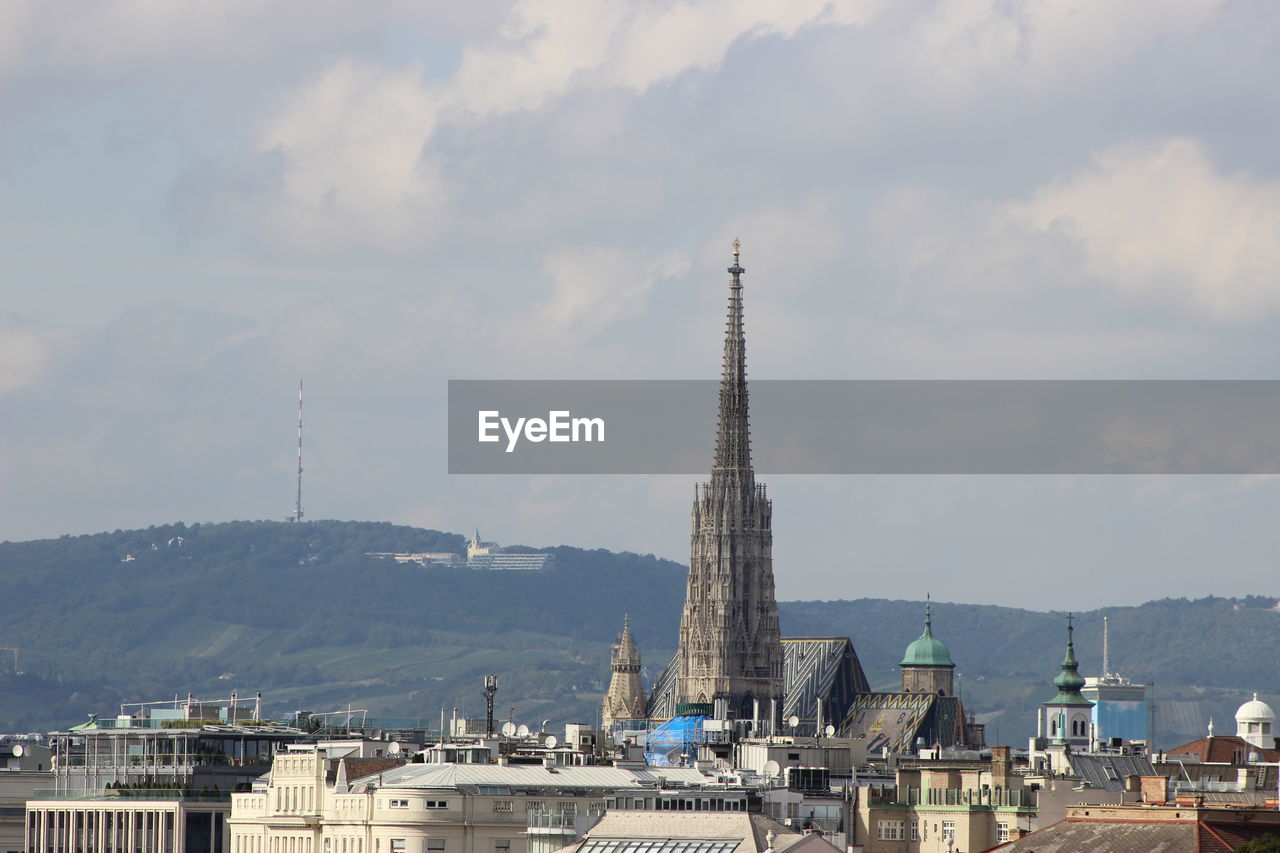 View of town against cloudy sky