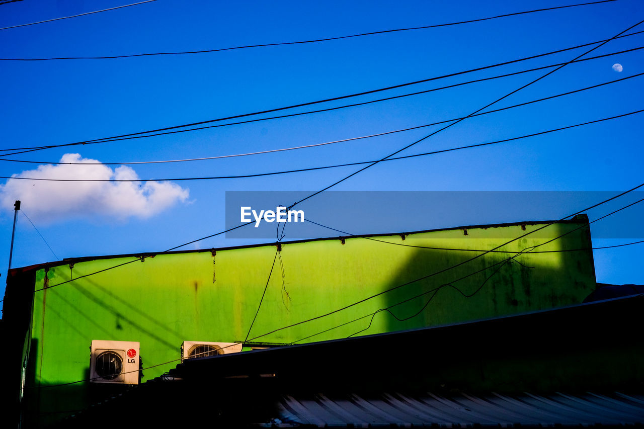 LOW ANGLE VIEW OF POWER LINES AGAINST BLUE SKY