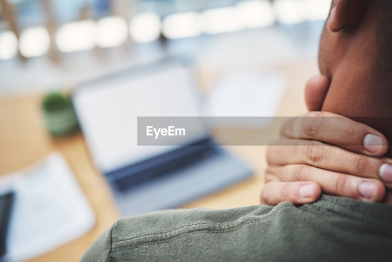 midsection of man using laptop