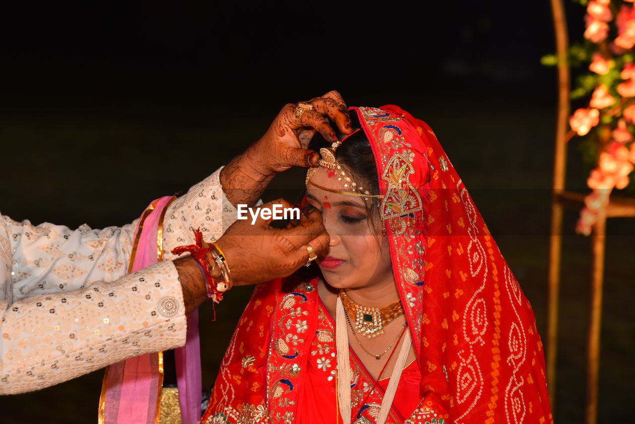 During the wedding ceremony, the groom puts sindoor on the hair  of his bride..