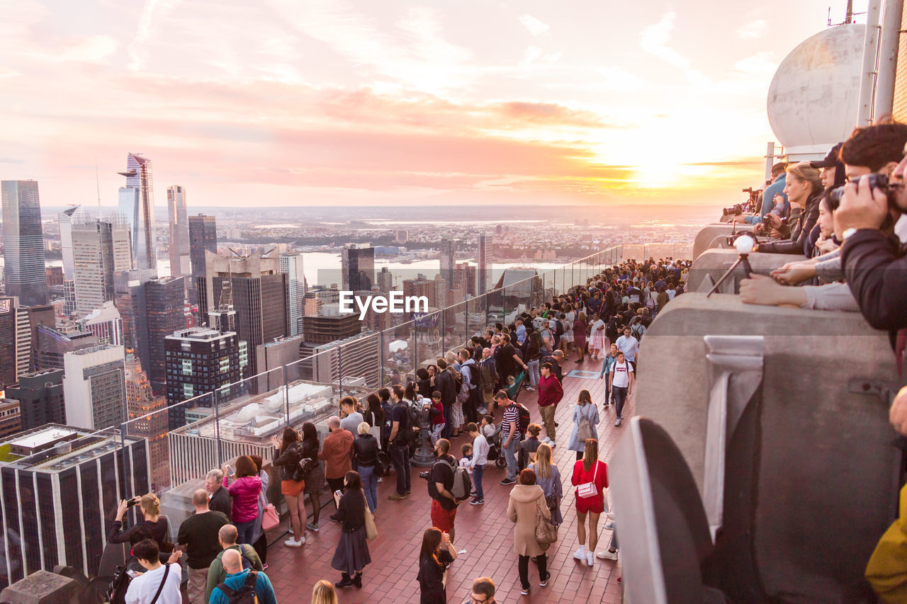 group of people in city during sunset