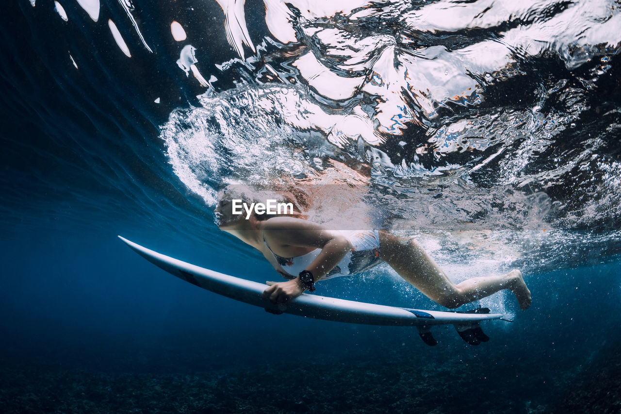 high angle view of man swimming in sea